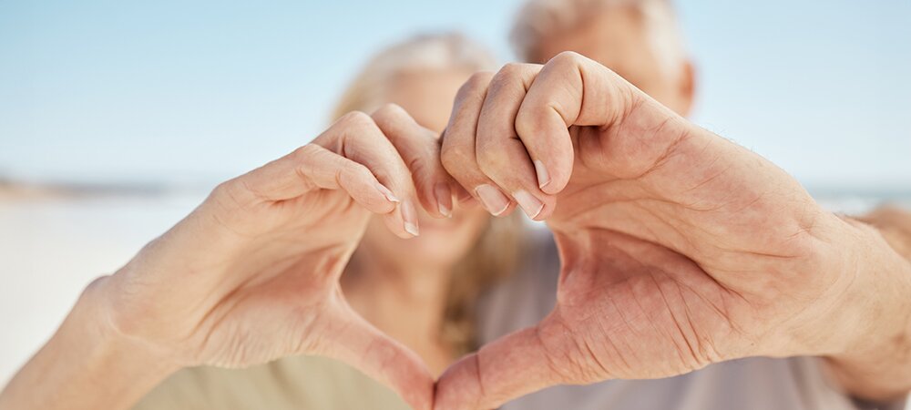 Image of a pair of couple make a heart shape with their hands